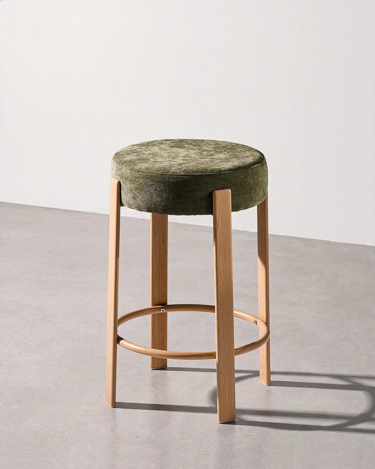 Bramley olive green chenille bar stool with a round upholstered seat and integrated footrest