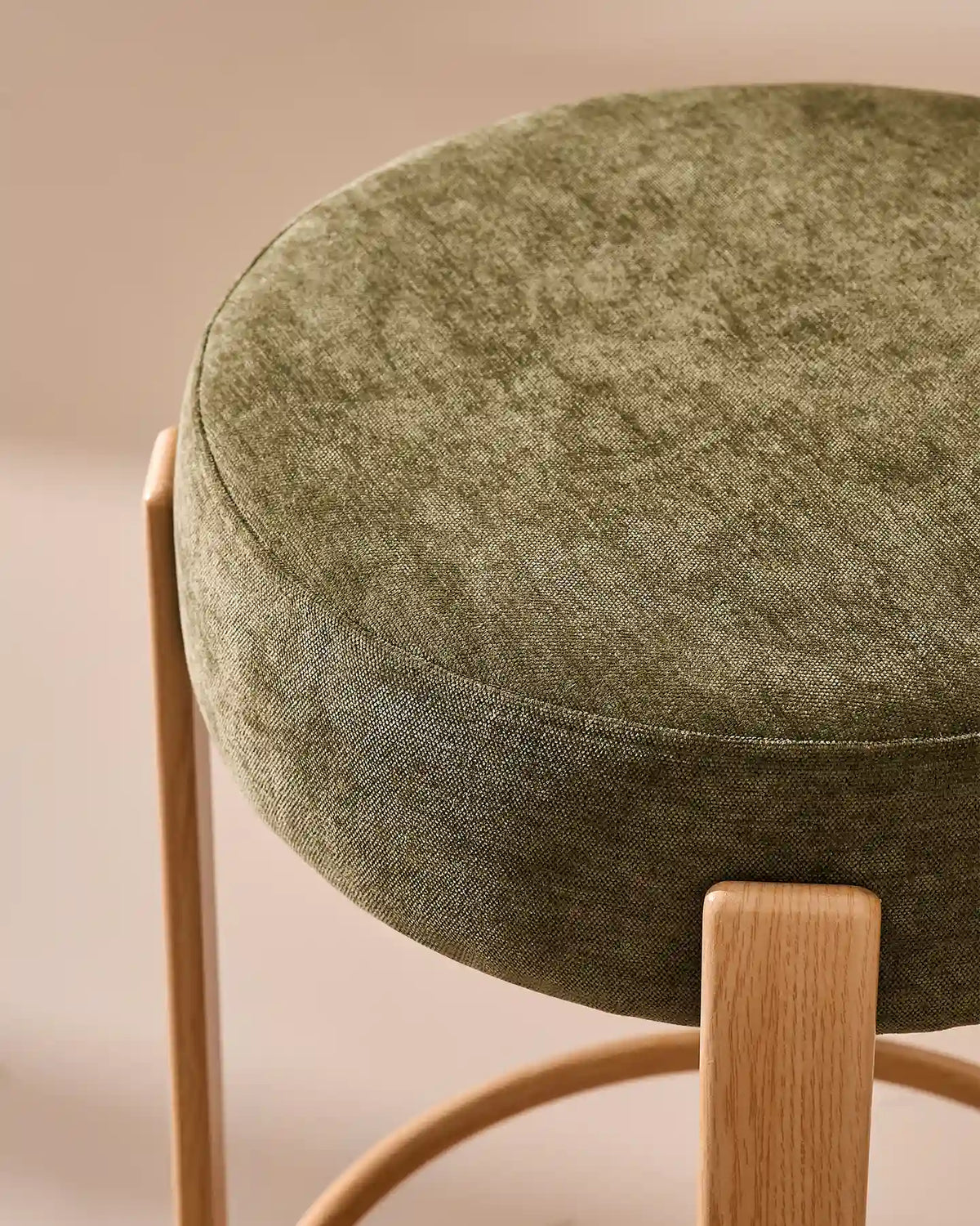 Close-up of the round seat with soft olive green chenille upholstery