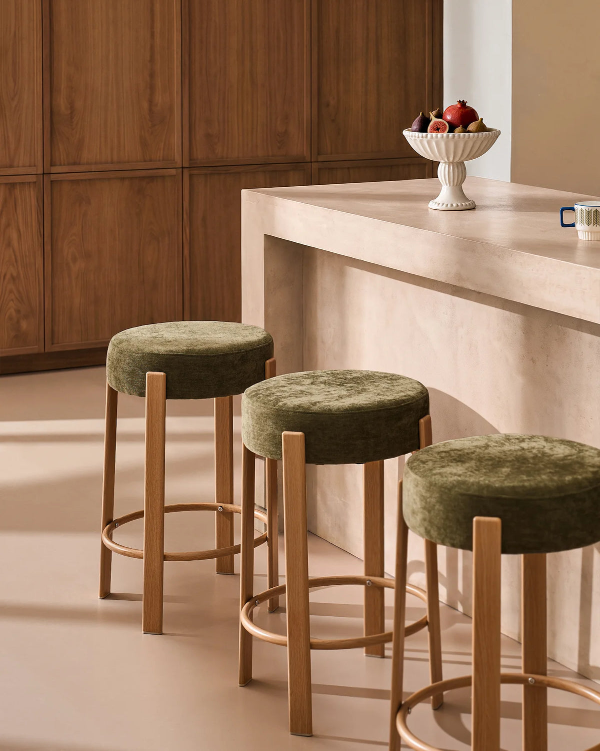Bramley olive green chenille bar stools styled around a modern kitchen island