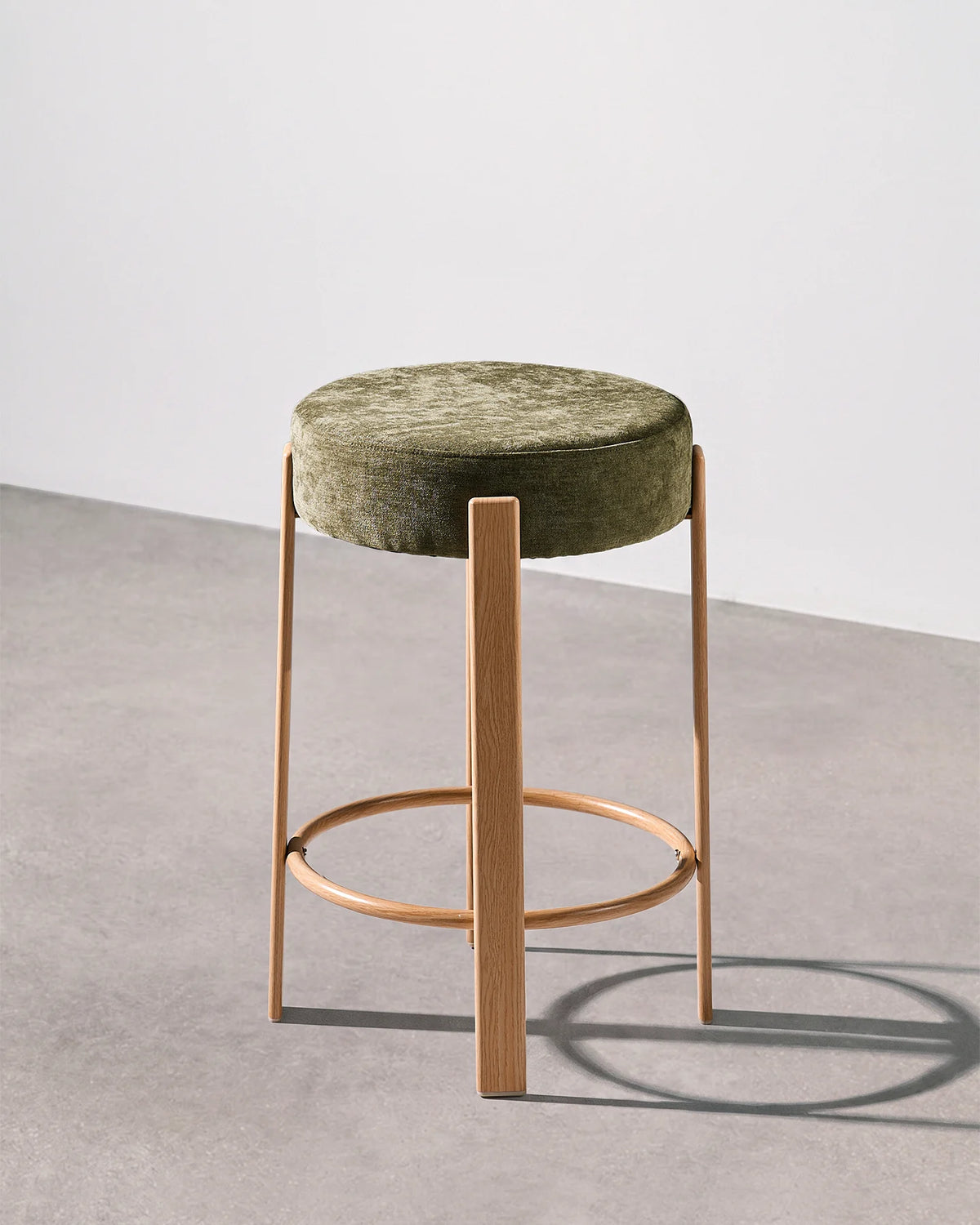 Bramley olive green chenille bar stool with a round upholstered seat and integrated footrest