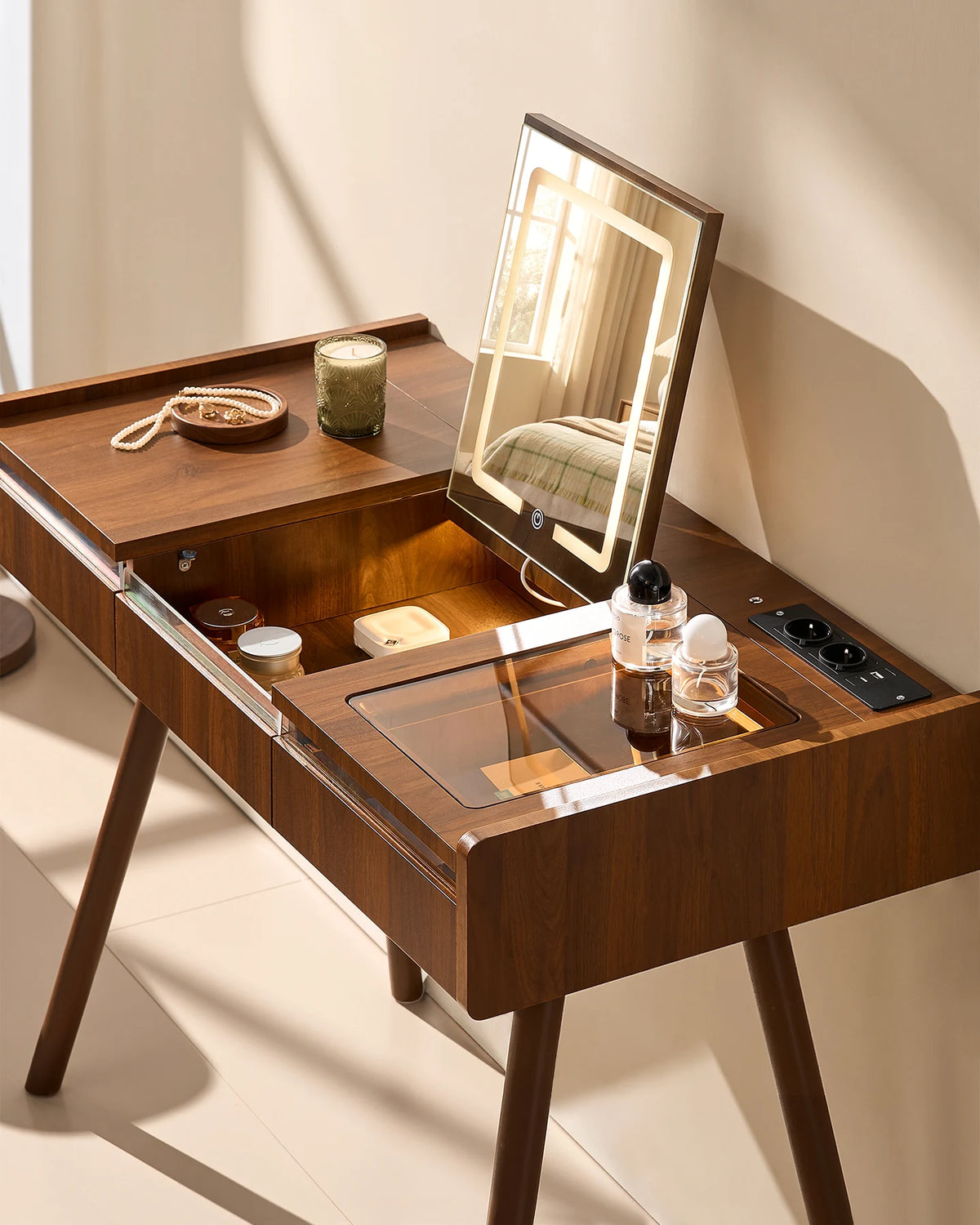 Top view of the Elora dressing table showing the central flip-top mirror and grey tempered-glass tabletop on the right