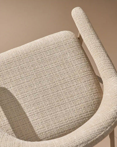 Close-up of chenille upholstery and taupe legs on Arlo Beige dining chairs