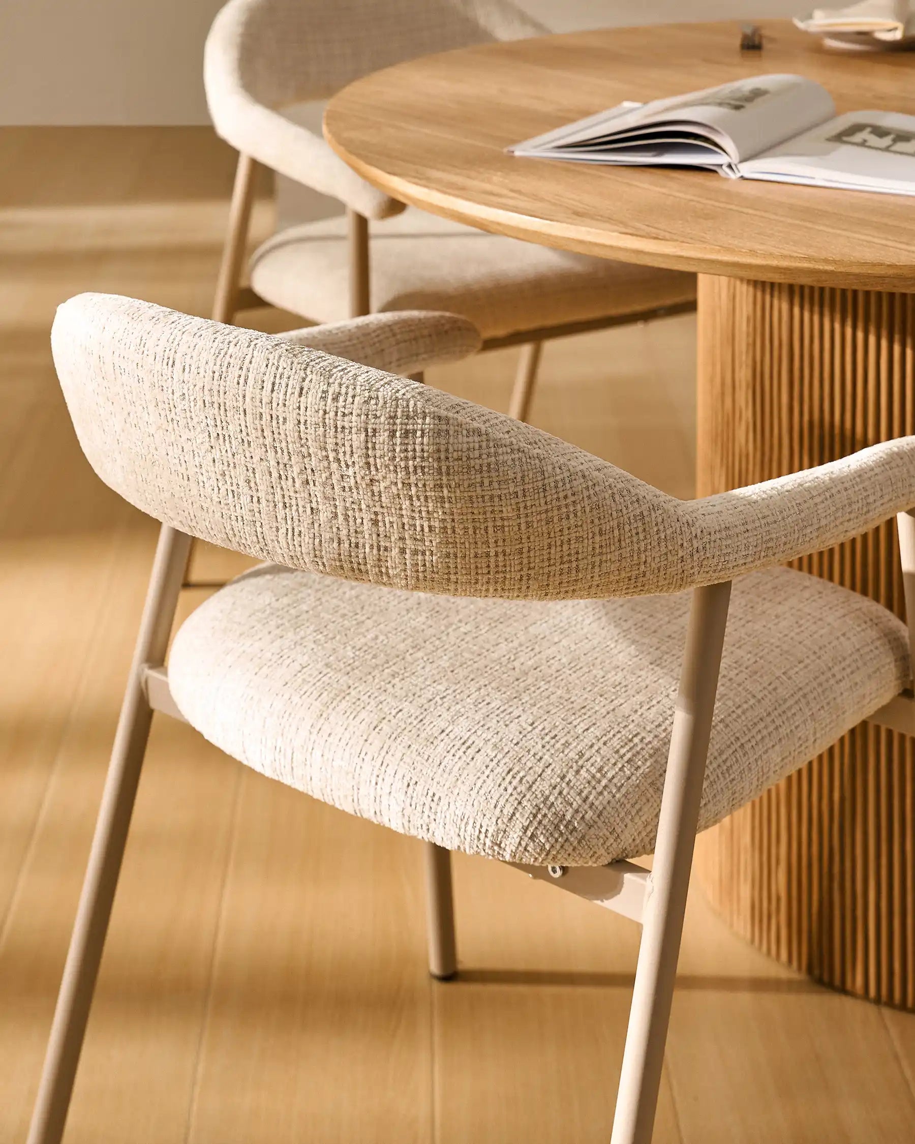 Side view of Arlo Beige chenille dining chairs with taupe legs