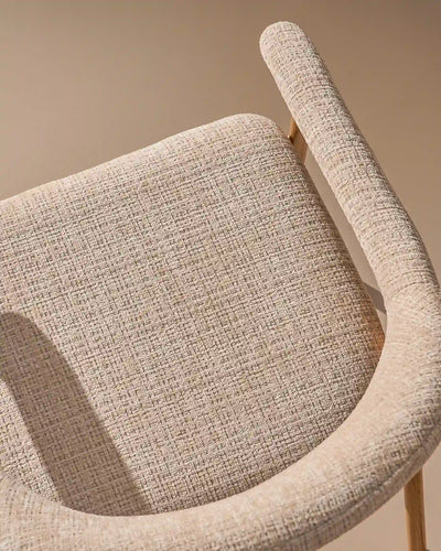 Close-up of chenille upholstery and oak-effect legs on Arlo dining chairs