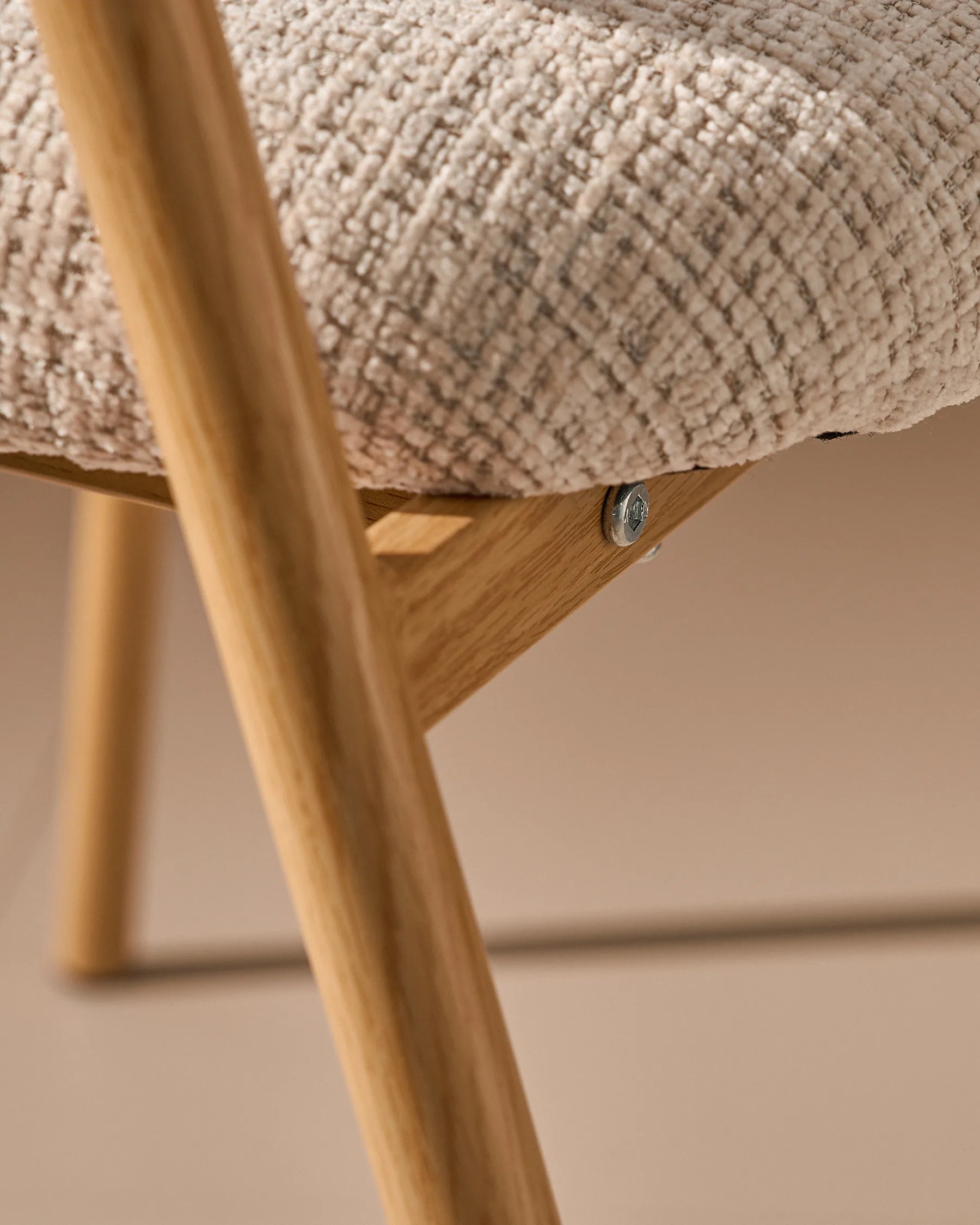 Close-up of chenille upholstery and oak-effect legs on Arlo dining chairs