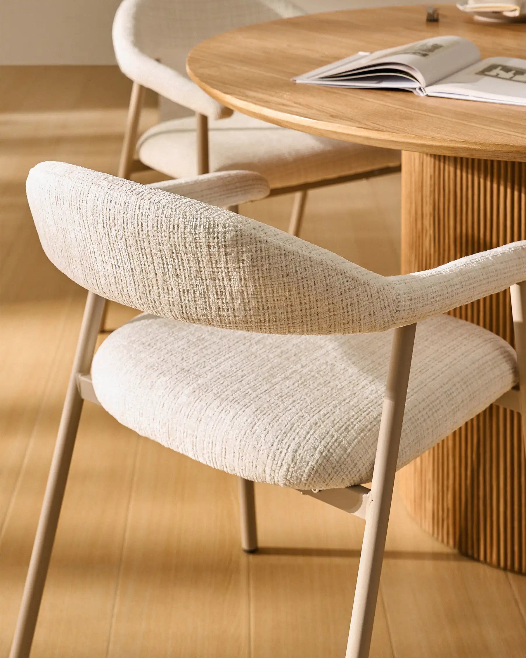 Side view of Arlo White chenille dining chairs with taupe legs