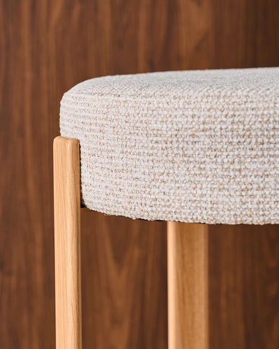 Close-up of the round seat with soft beige chenille upholstery