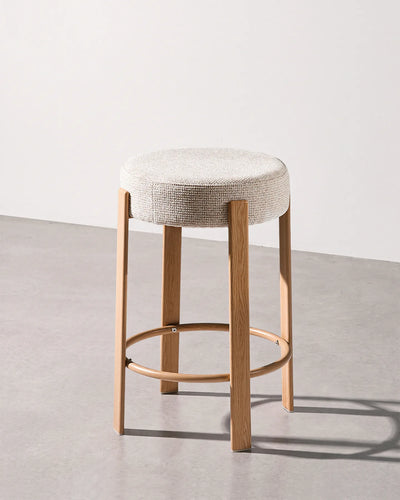 Bramley beige chenille bar stool with a round upholstered seat and integrated footrest