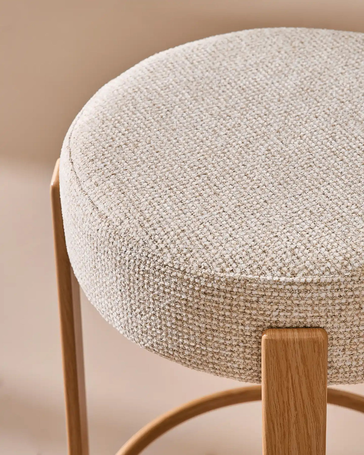 Close-up of the round seat with soft beige chenille upholstery