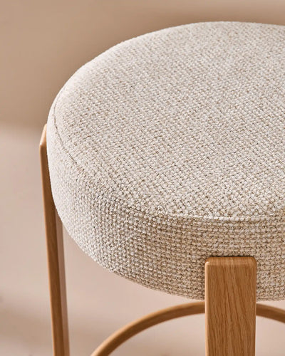Close-up of the round seat with soft beige chenille upholstery