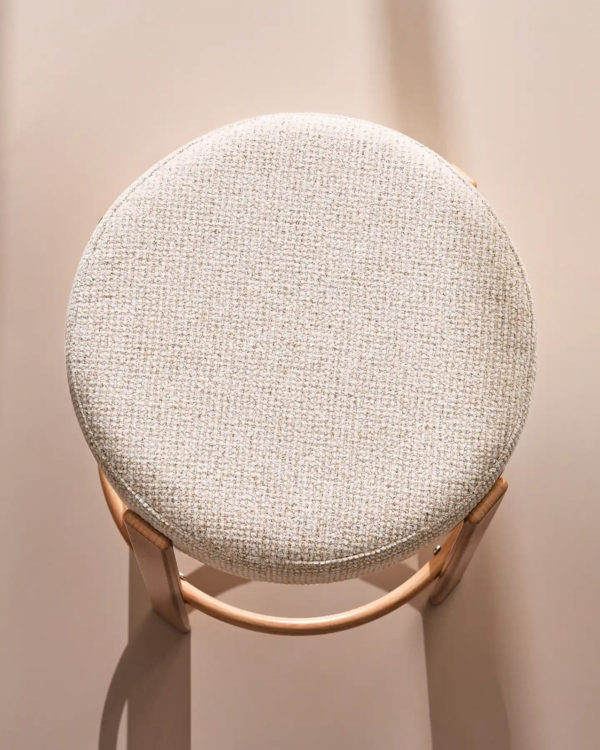 Close-up of the round seat with soft beige chenille upholstery