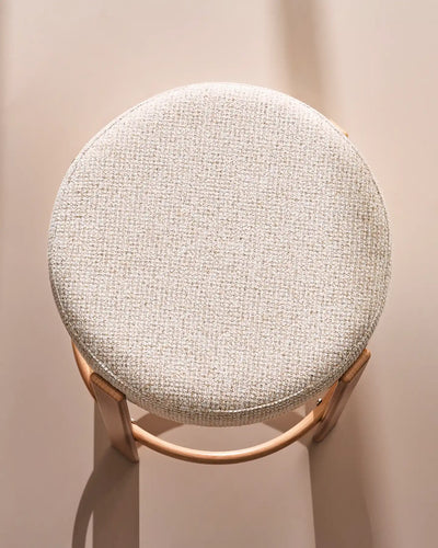 Close-up of the round seat with soft beige chenille upholstery