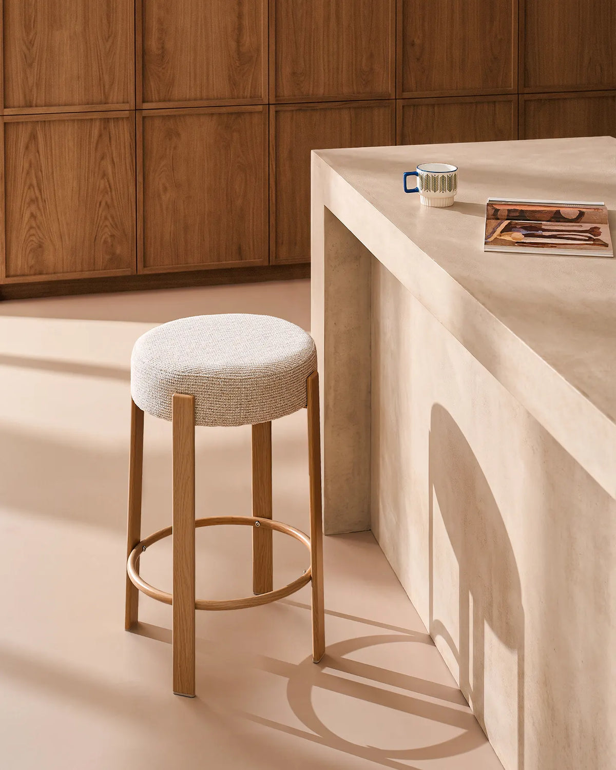 Side view of the Bramley beige chenille bar stool with 65 cm seat height and oak-effect metal frame