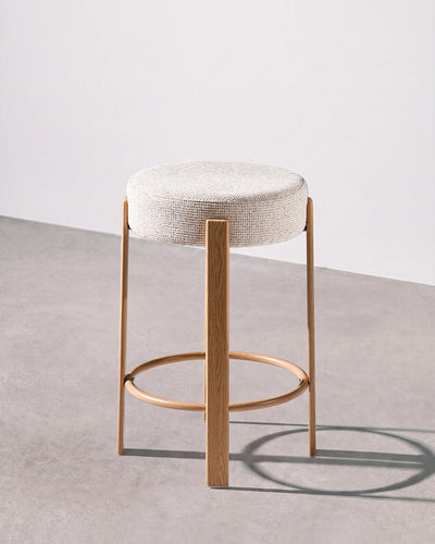 Bramley beige chenille bar stool with a round upholstered seat and integrated footrest