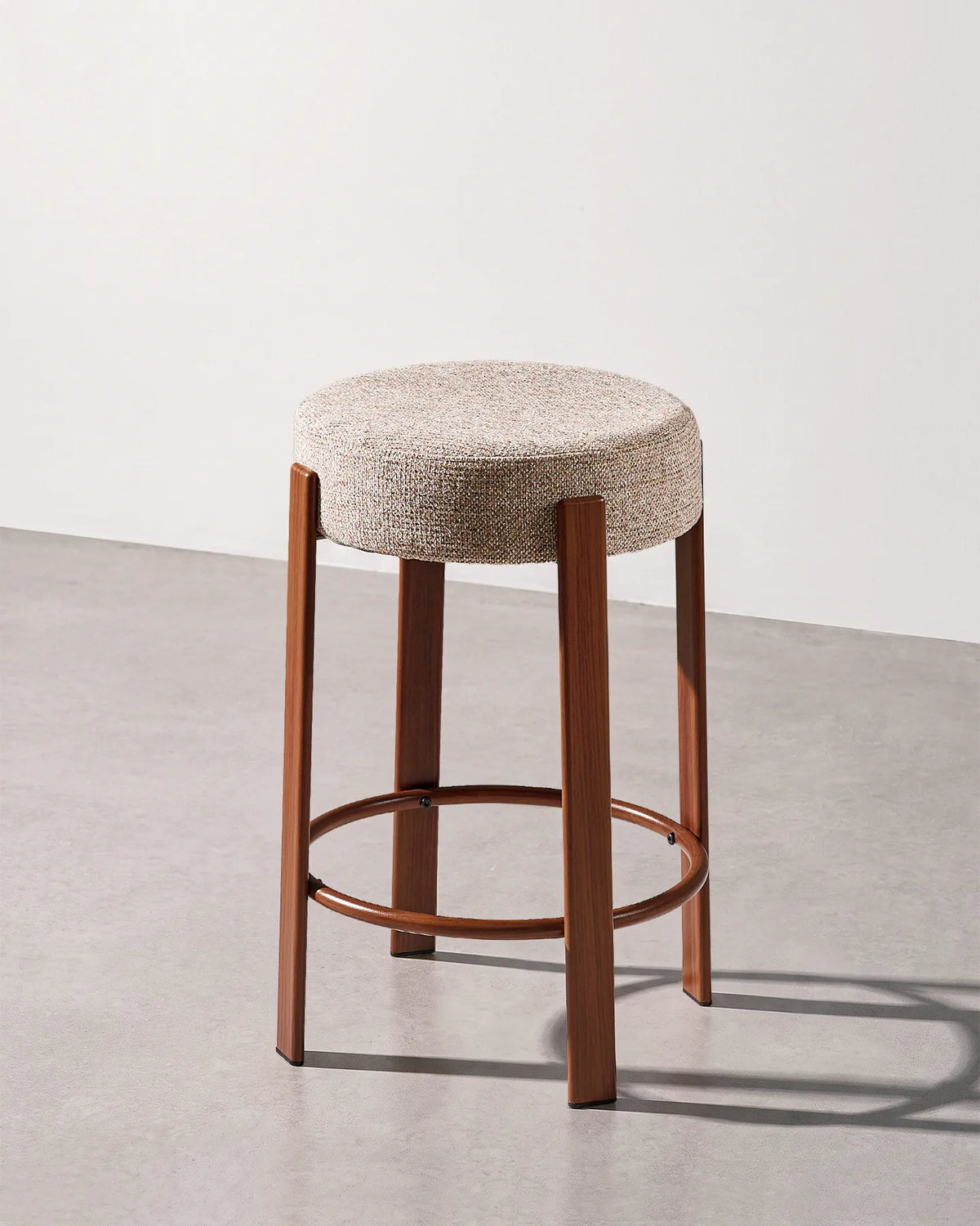 Bramley light taupe chenille bar stool with a round upholstered seat and integrated footrest
