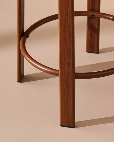 Detail of the integrated footrest on the walnut-effect metal frame of the Bramley bar stool