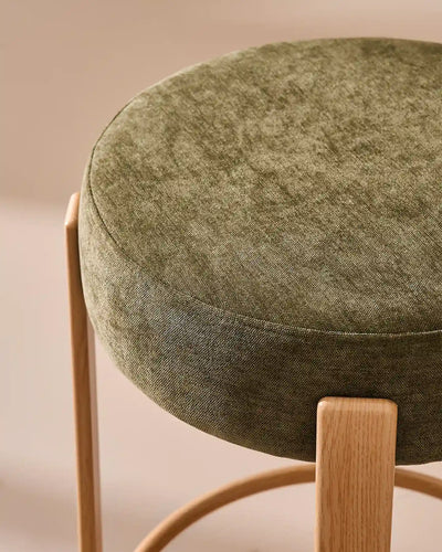 Close-up of the round seat with soft olive green chenille upholstery