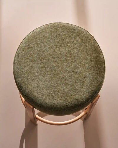 Close-up of the round seat with soft olive green chenille upholstery