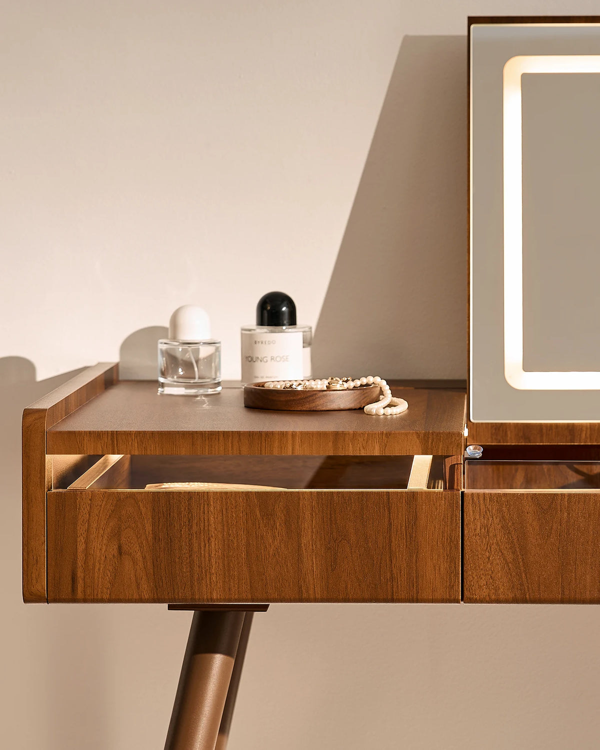 Concealed storage compartment beneath the flip-top mirror of the Elora dressing table
